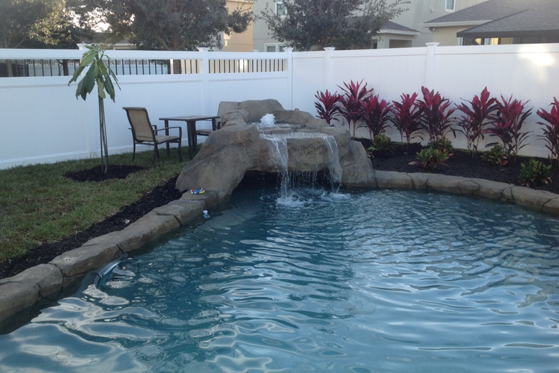 handcrafted natural pool in Orlando with a cave waterfall