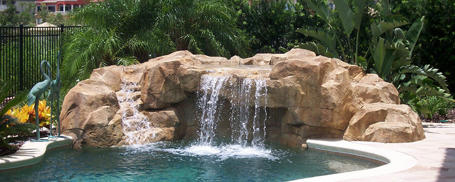 handcrafted natural pool with a cave waterfall